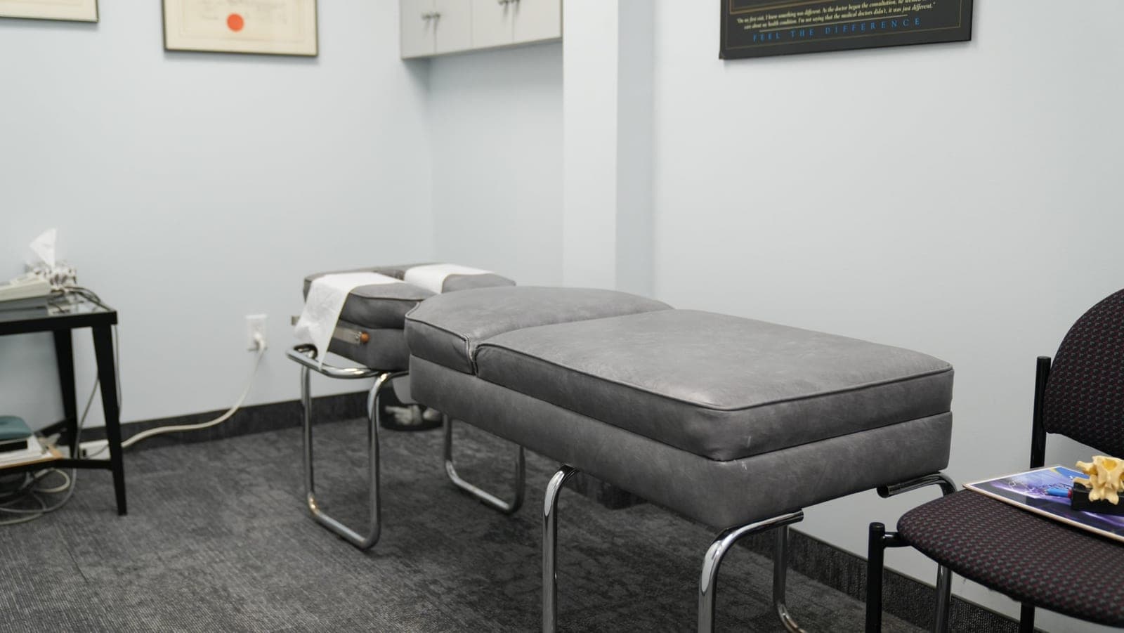 Chiropractic treatment room at Life Chiropractic Centre in Burlington, ON featuring adjustment table and patient seating