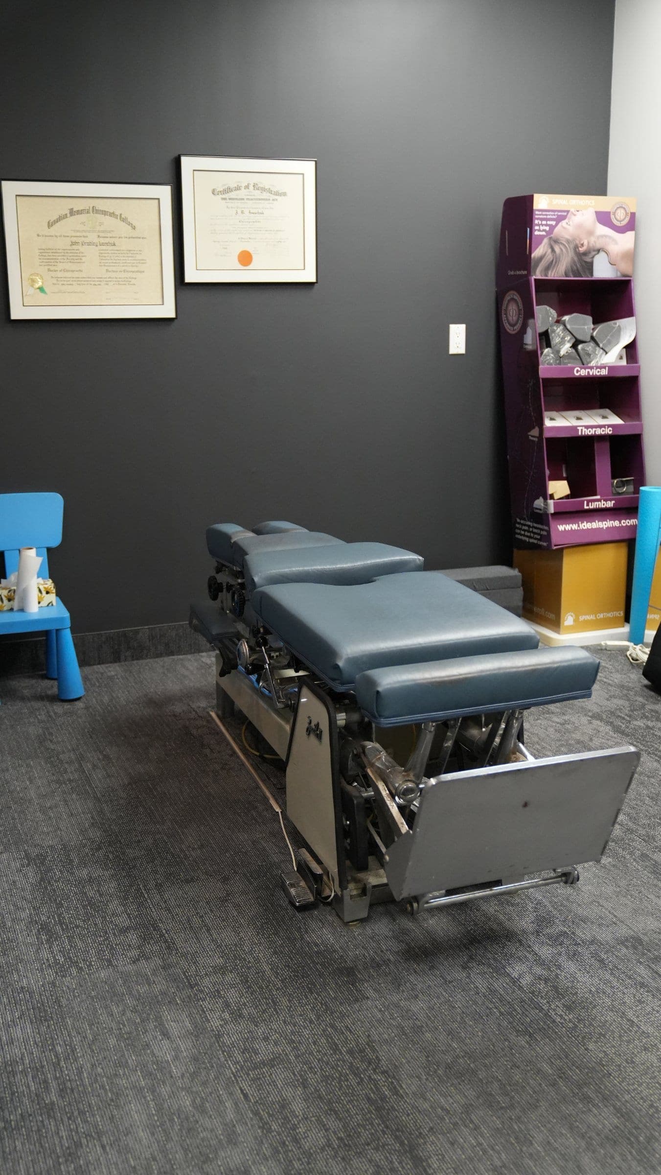 Chiropractic treatment room at Life Chiropractic Centre in Burlington, ON featuring an adjustment table and spine model display