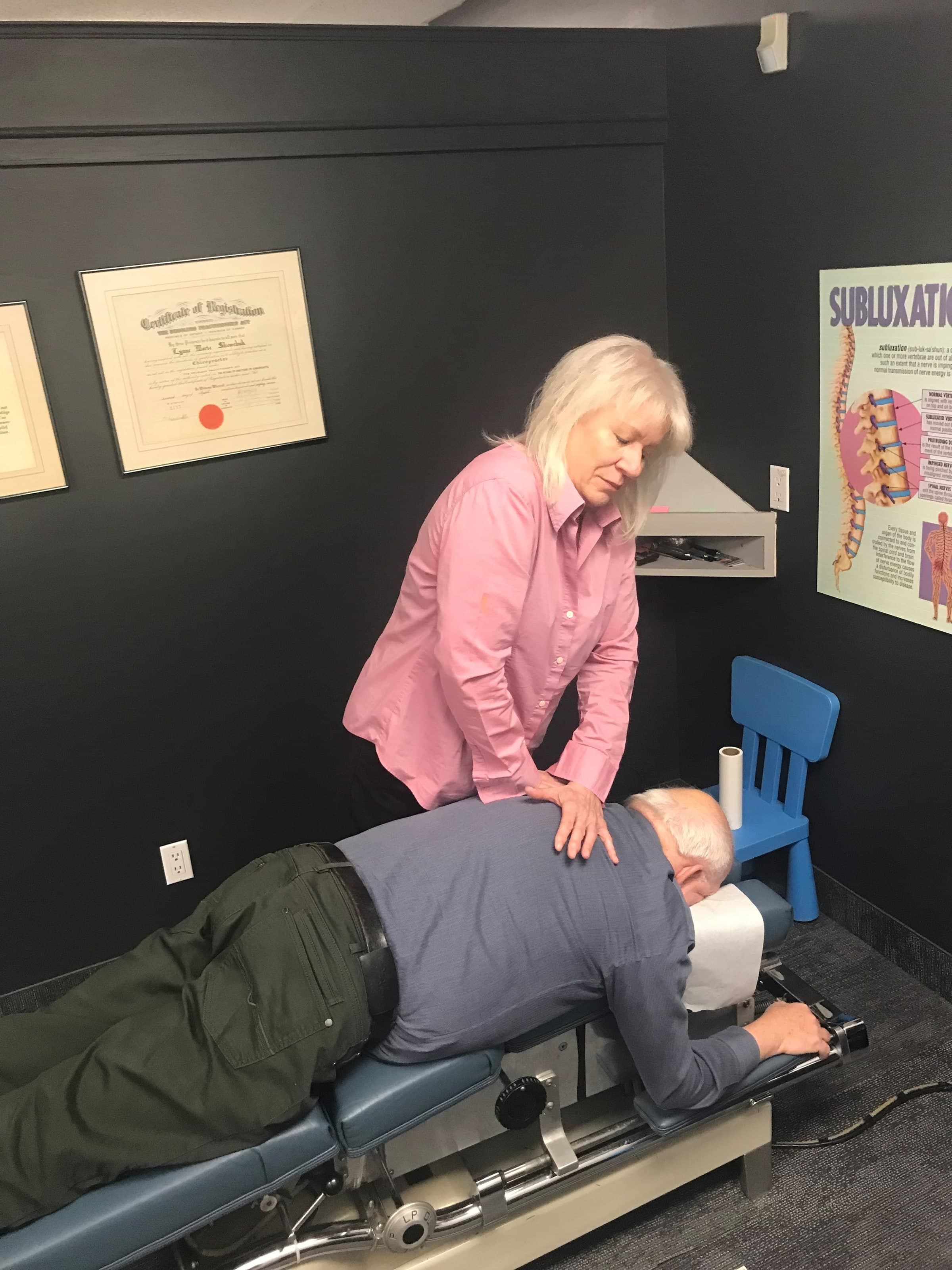 Dr. Lynne Shewchuk applies a light-touch Matrix Repatterning treatment to a patient's back at Life Chiropractic Centre in Burlington