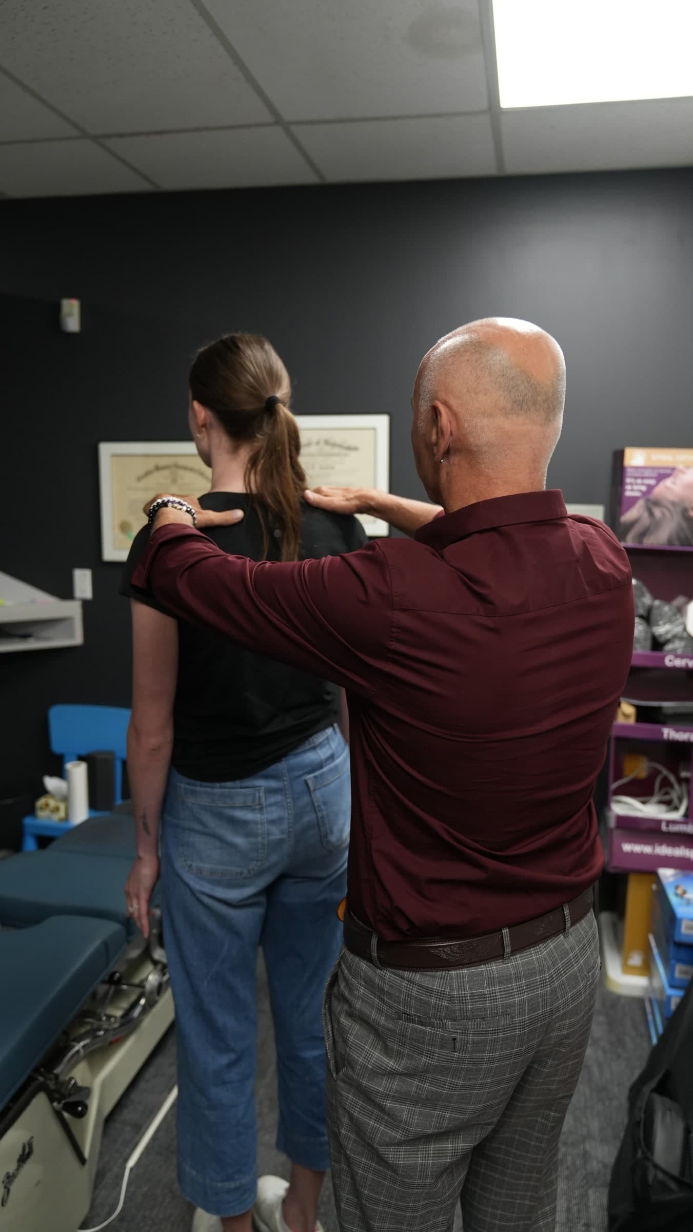 Chiropractor performing spinal examination on patient in treatment room at Life Chiropractic Centre, Burlington, ON