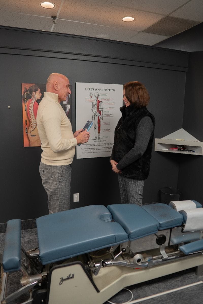 Chiropractor reviewing a spine chart with a patient at Life Chiropractic Centre, Burlington